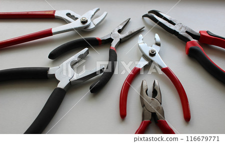Set Of Different Types Of Mechanics Pliers On White Surface Detailed Stock Photo Set Of Different Types Of Mechanics Pliers On White Surface Detailed Stock Photo 116679771