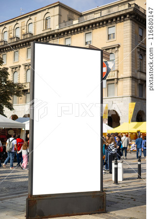 Vertical billboard in the city on the sidewalk. Mock up for advertising or announcements. Advertising space under the poster. Light poster 116680147