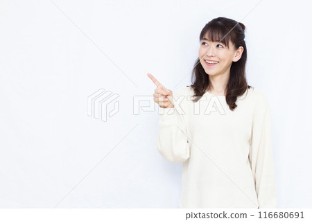 A woman who raises her index finger with a smile A woman who raises her index finger with a smile 116680691