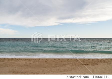 Empty sand beach on Mediterranean sea with horizon line vacation background 116681119