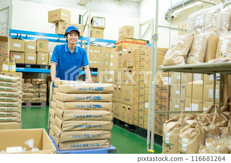 Young male driver working in warehouse 116681264