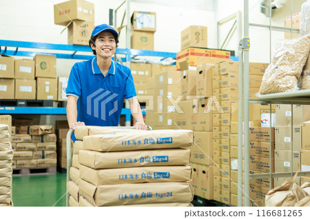 Young male driver working in warehouse 116681265