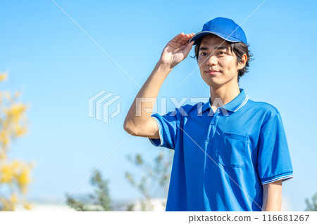 A young male driver in work clothes wearing a hat A young male driver in work clothes wearing a hat 116681267