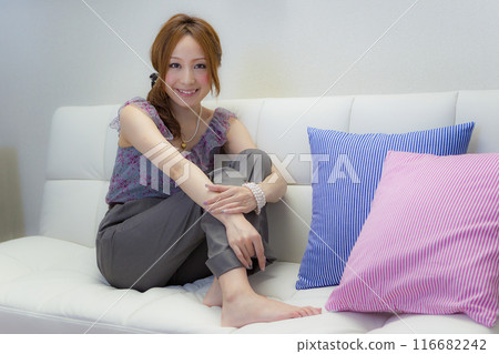 A woman sitting on a sofa A woman sitting on a sofa 116682242