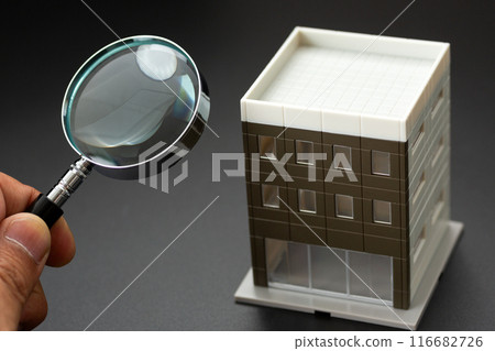 Real estate security image (office building and magnifying glass) 116682726