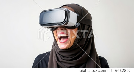 Arab young woman experiencing virtual reality with joyful expression 116682802