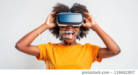 Teenager black girl experiencing virtual reality with joyful expression 116682807