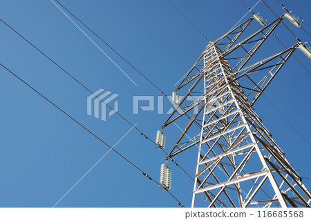 High Voltage Pole Against Blue Sky 116685568