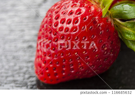 Close up of strawberry on black cover background. Healthy food and fruits concept Close up of strawberry on black cover background. Healthy food and fruits concept 116685632