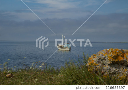 a small old wooden fishing boat 116685897