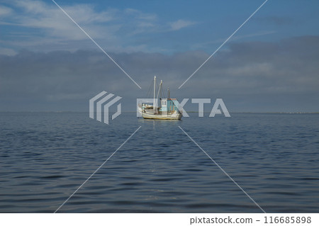 a small old wooden fishing boat 116685898