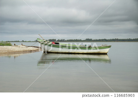 lonely fishing boat docked in sea. lonely fishing boat docked in sea. 116685903