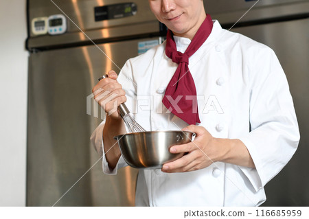 Asian male pastry chef working in the kitchen 116685959