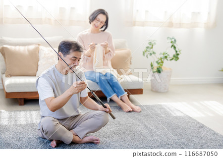 A middle-aged couple spending their holidays in the living room 116687050
