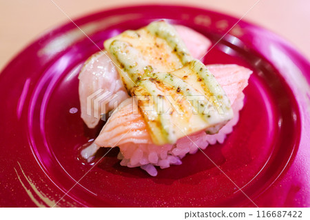 Top view of Japanese fresh salmon sushi with Japanese rice in red plate, focus selective Top view of Japanese fresh salmon sushi with Japanese rice in red plate, focus selective 116687422