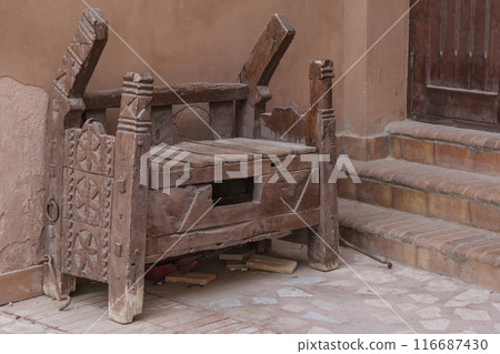 Rustic Wooden Bench with Intricate Carvings 116687430
