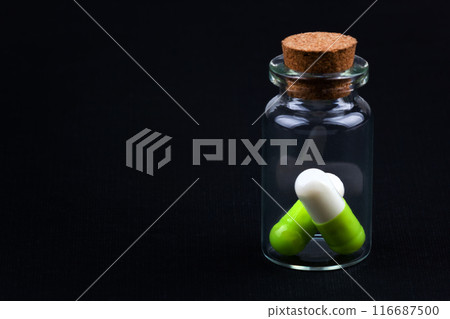 glass jar with colorful pills glass jar with colorful pills 116687500