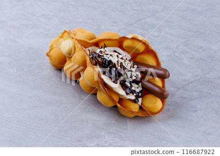 Delicious sweet bubble waffles on grey table 116687922