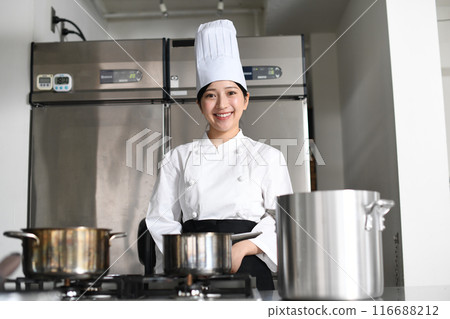 Young asian female chef cooking in the kitchen 116688212