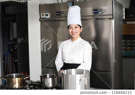 Young asian female chef cooking in the kitchen 116688215