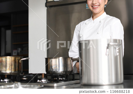 Young asian female chef cooking in the kitchen 116688218