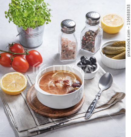 Solyanka soup is a traditional Russian soup in a bowl with olives, meat and pickles Solyanka soup is a traditional Russian soup in a bowl with olives, meat and pickles 116688838