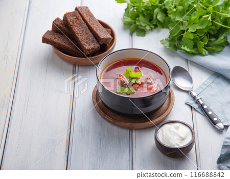 Traditional Ukrainian Russian borsch (beetroot soup) with meat in a black bowl Traditional Ukrainian Russian borsch (beetroot soup) with meat in a black bowl 116688842