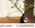 The flower arrangement in the elegant vase creates a very calming atmosphere. 116688968