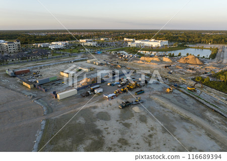 Development of residential housing in US suburbs. Beginning of construction works on prepared ground. Large building site with scattered equipment in american rural area. Real estate market in USA Development of residential housing in US suburbs. Beginning of construction works on prepared ground. Large building site with scattered equipment in american rural area. Real estate market in USA 116689394