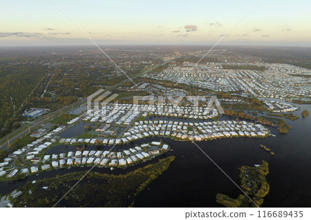 Consequences of natural disaster. Heavy flood with high water surrounding residential houses after hurricane rainfall in Florida residential area 116689435
