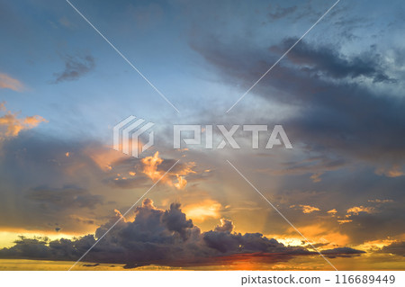 Colorful evening landscape with soft pastel coloured clouds on watercolor tinted sunset sky. Abstract nature background 116689449