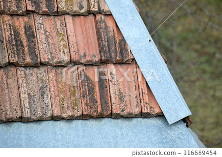 Closeup surface of old weathered ceramic tiles covering building roof Closeup surface of old weathered ceramic tiles covering building roof 116689454