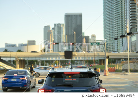 Cars traffic driving at intersection on American street with traffic lights in Miami, Florida. USA transportation 116689494