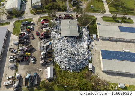 Beg pile of scrap aluminum metal siding from ruined houses after hurricane Ian swept through Florida. Recycle of broken parts of mobile homes Beg pile of scrap aluminum metal siding from ruined houses after hurricane Ian swept through Florida. Recycle of broken parts of mobile homes 116689529