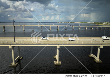 Barron Collier Bridge and Gilchrist Bridge in Florida with moving traffic. Transportation infrastructure in Charlotte County connecting Punta Gorda and Port Charlotte over Peace River 116689540