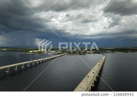 Barron Collier Bridge and Gilchrist Bridge in Florida with moving traffic. Transportation infrastructure in Charlotte County connecting Punta Gorda and Port Charlotte over Peace River 116689541