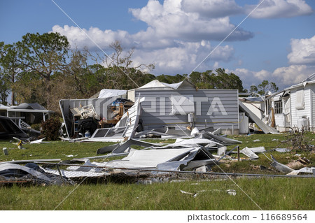 Aftermath of natural disaster in southern Florida. Badly damaged mobile homes after hurricane swept through residential area Aftermath of natural disaster in southern Florida. Badly damaged mobile homes after hurricane swept through residential area 116689564
