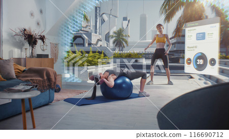 Sportswoman in AR headset exercises with fitball. VR screen shows virtual trainer and fitness app Sportswoman in AR headset exercises with fitball. VR screen shows virtual trainer and fitness app 116690712