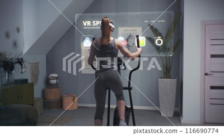 Female athlete wearing virtual reality headset starts training on orbitrek Female athlete wearing virtual reality headset starts training on orbitrek 116690774