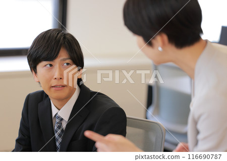 A businessman whose face is stiffened by criticism from his female boss_1 A businessman whose face is stiffened by criticism from his female boss_1 116690787