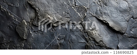 Close Up Of A Cracked And Rough Dark Grey Rock Surface 116690825