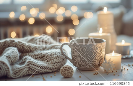 Cozy Winter Scene With a White Mug, Knitted Blankets, and Burning Candles 116690845