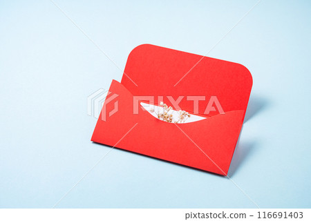 Red envelope with white letter and flowers  on a blue  background. The concept of Valentine's Day 116691403