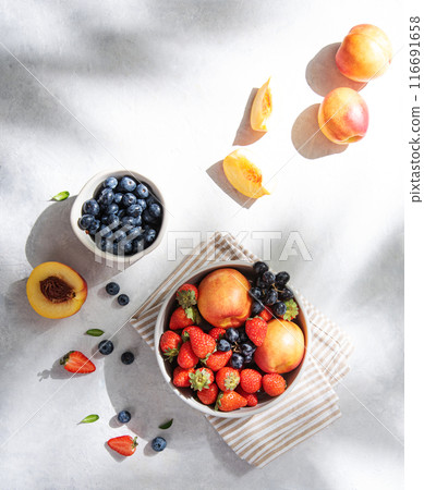 Fresh organic summer berries and fruits of strawberries, blueberries, peaches and grapes Fresh organic summer berries and fruits of strawberries, blueberries, peaches and grapes 116691658