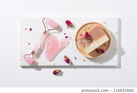 flat lay with natural cosmetic products soap and pink gua sha on white background. Top view flat lay with natural cosmetic products soap and pink gua sha on white background. Top view 116691660