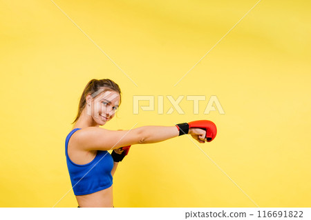Sports, boxing gloves and portrait of woman punching with confidence and motivation Sports, boxing gloves and portrait of woman punching with confidence and motivation 116691822