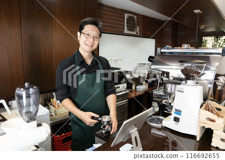 Coffee shop manager making coffee Coffee shop manager making coffee 116692655