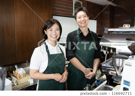 Smiling coffee shop manager and employee Smiling coffee shop manager and employee 116692711