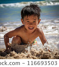 A boy playing on a sandy beach 116693503
