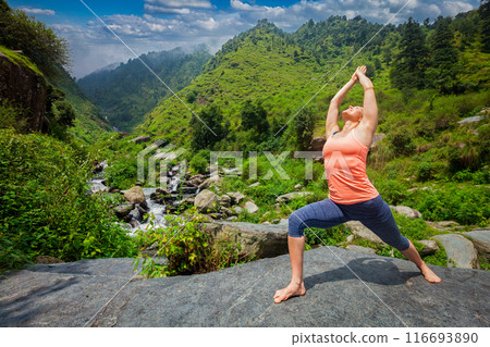 Woman doing Ashtanga Vinyasa Yoga asana Virabhadrasana 1 Warrior Woman doing Ashtanga Vinyasa Yoga asana Virabhadrasana 1 Warrior 116693890